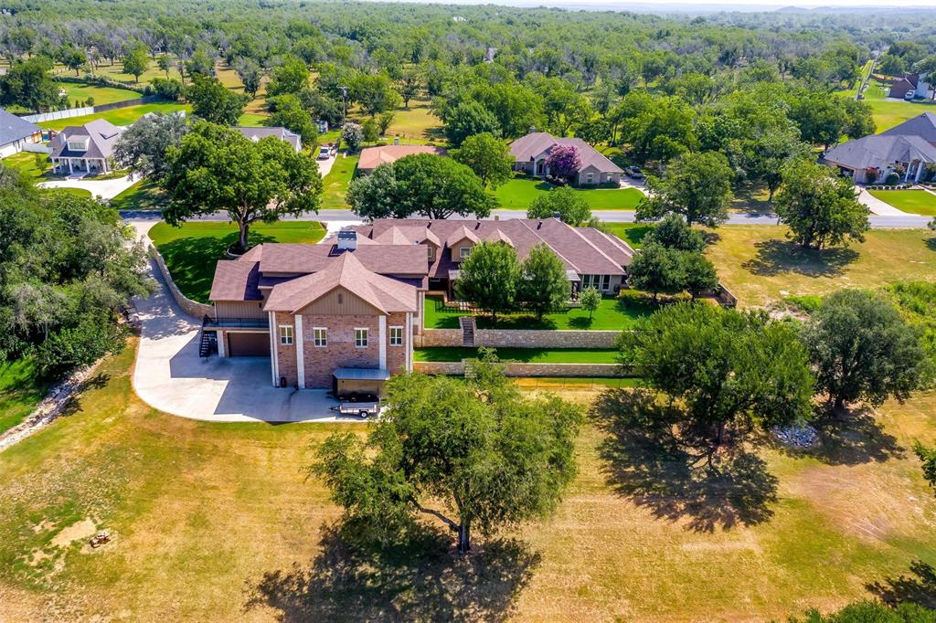 9310 Bellechase Road Granbury, TX 76049 - Photo 4 of 39 an aerial view of house with yard swimming pool and outdoor seating