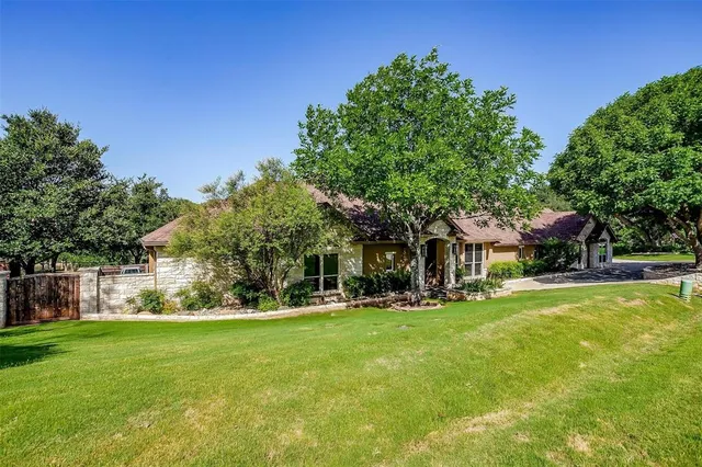 a front view of house with yard and green space