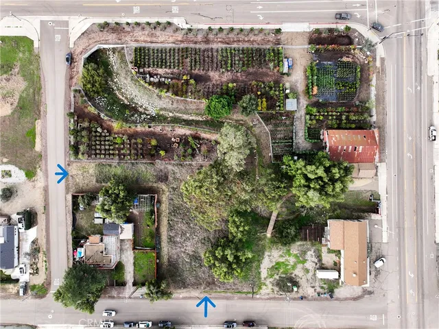 an aerial view of a residential houses with cars park