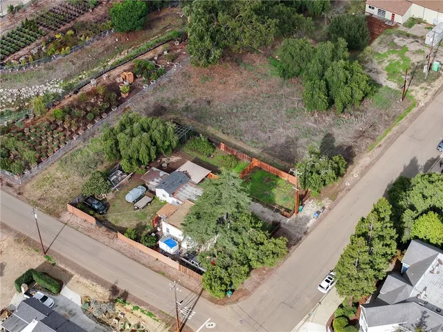 an aerial view of residential houses with outdoor space and river
