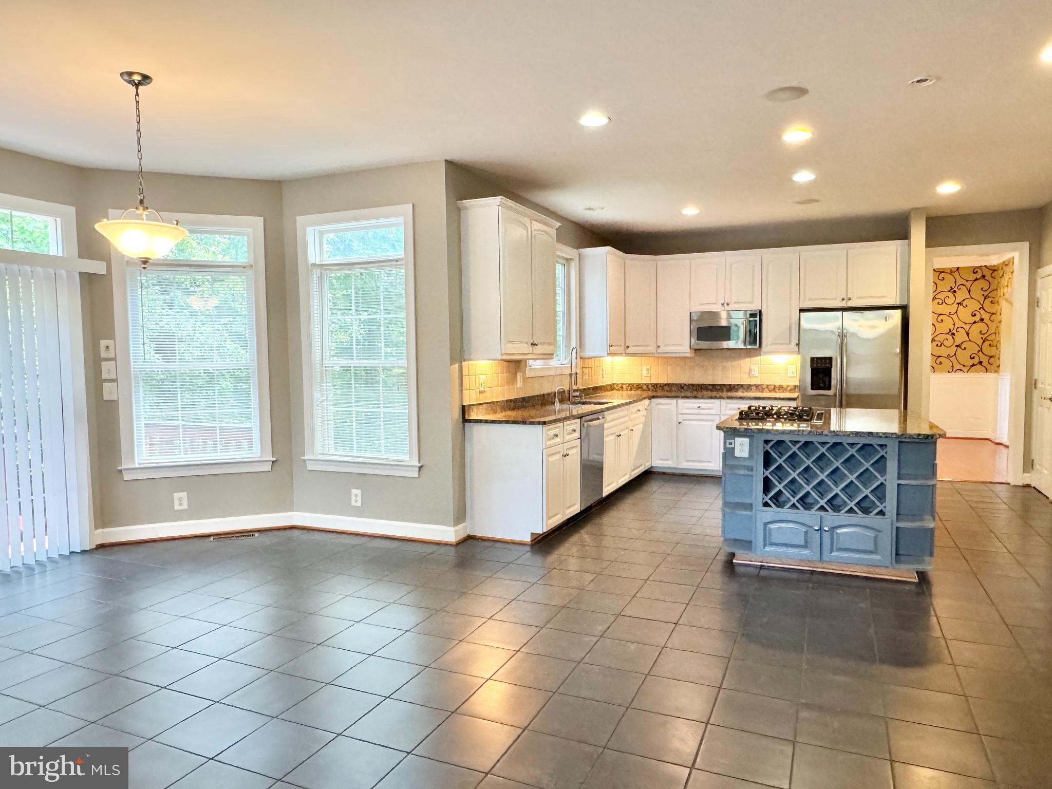 3500 Germainia Court Triangle, VA 22172 - Photo 14 of 77 a kitchen with stainless steel appliances granite countertop a stove top oven a sink a counter top space cabinets and a window