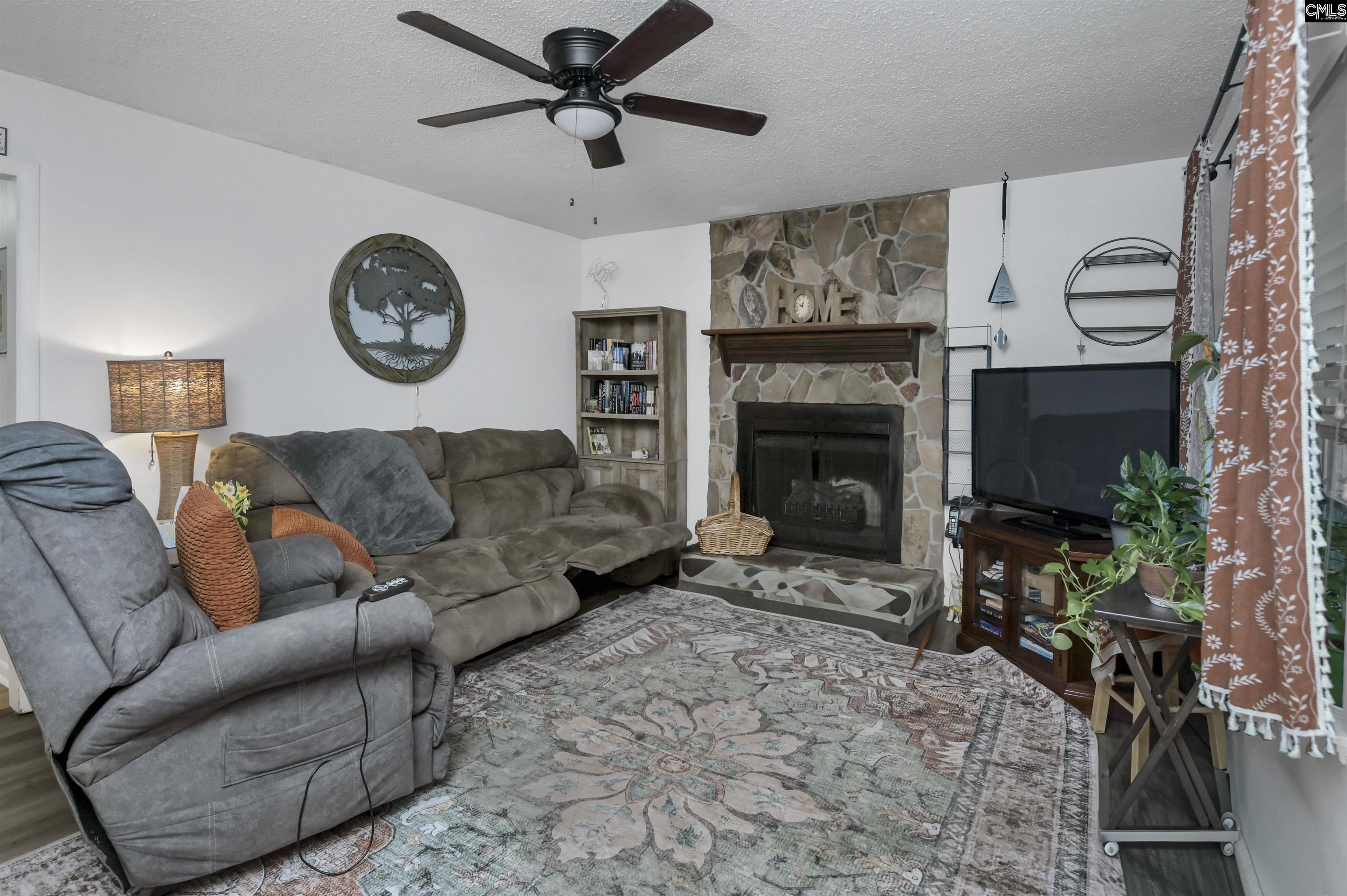 133 Sunset Strip Elgin, SC 29045 - Photo 9 of 30 a living room with furniture a clock and a fireplace