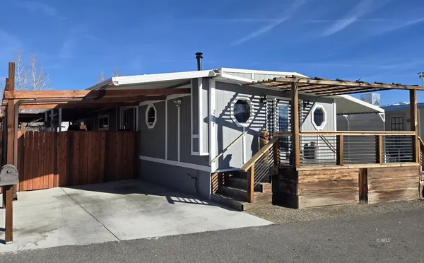 a view of a house with a wooden fence