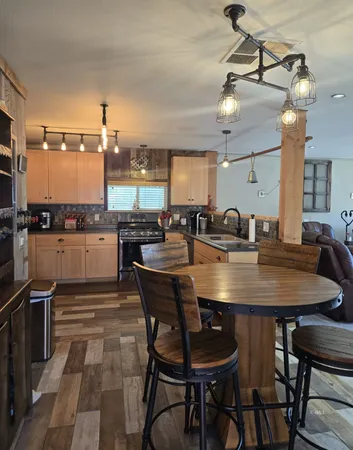a kitchen with a table chairs stove and cabinets