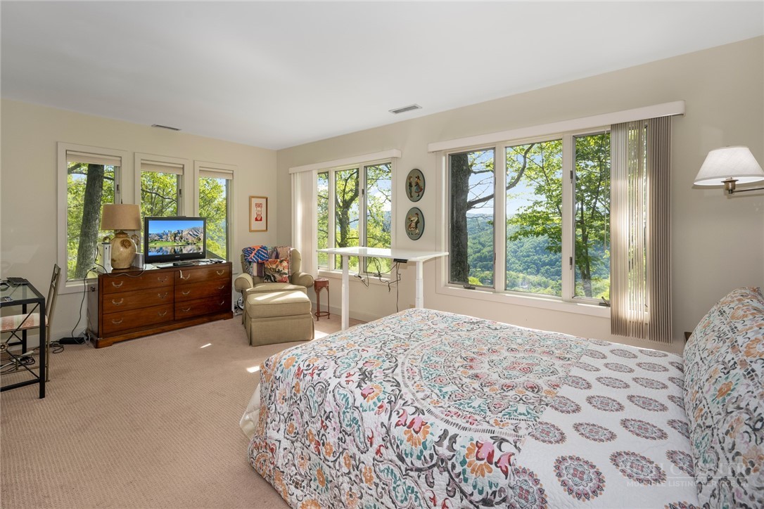 246 Mulberry Lane Boone, NC 28607 - Photo 43 of 49 a spacious bedroom with a bed and large windows