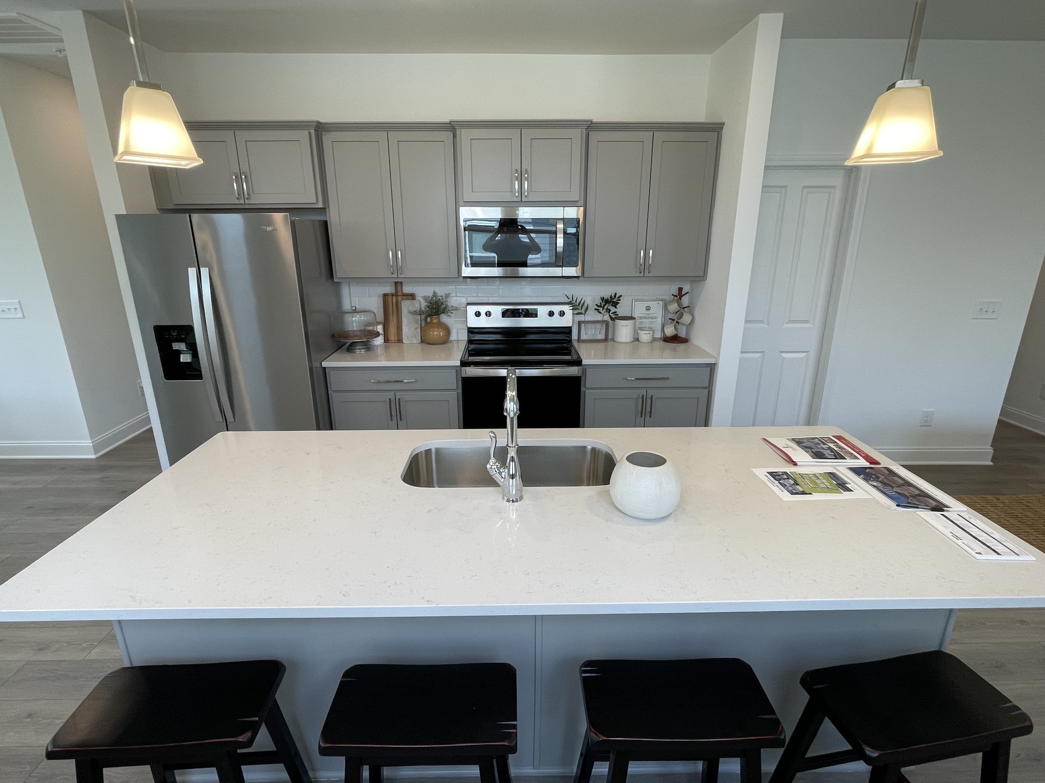 1146 June Wilde Ridge Spring Hill, TN 37174 - Photo 5 of 18 a kitchen with kitchen island a stove two chairs and a refrigerator