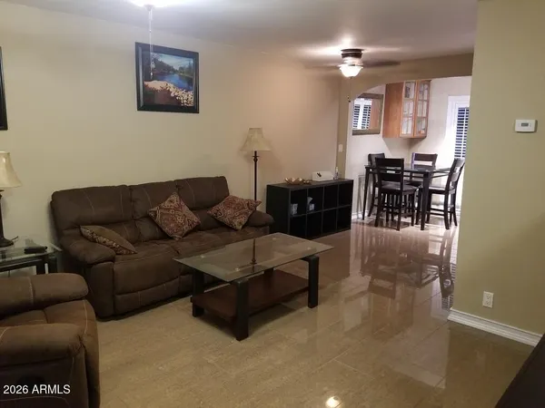 a living room with furniture and a dining area