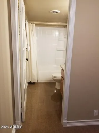 a bathroom with a shower and a toilet