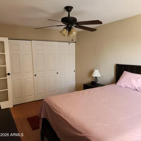 a bedroom with a bed and a chandelier