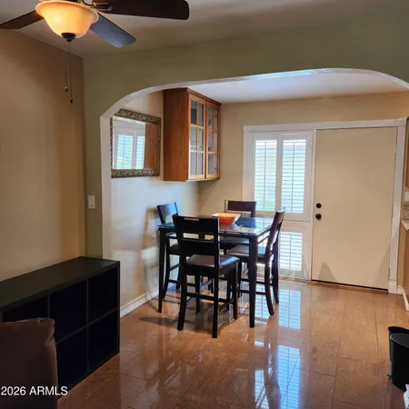 a view of a dining room with furniture and chandelier