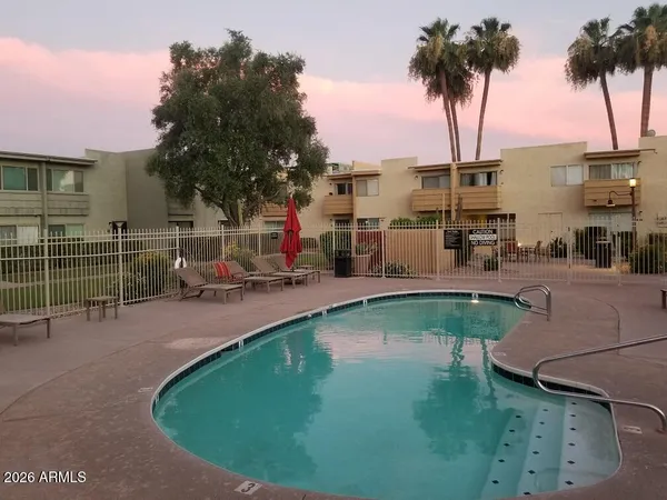 a swimming pool with outdoor seating and yard