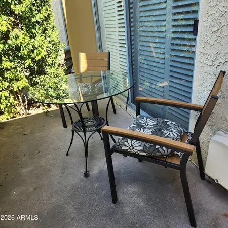 a balcony with table and chairs