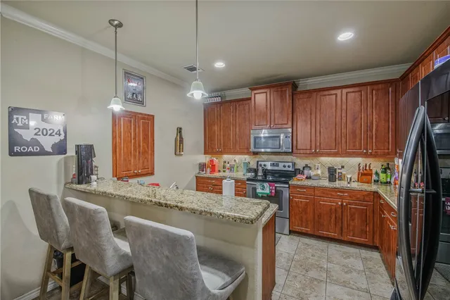 a kitchen with stainless steel appliances granite countertop sink stove top oven and cabinets