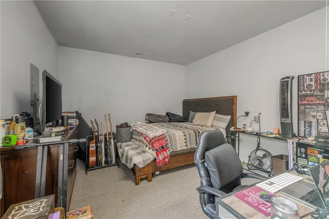 a bedroom with furniture and a flat screen tv