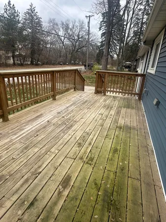 a view of balcony with wooden floor and fence