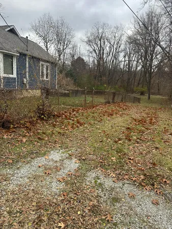 a backyard of a house with large trees