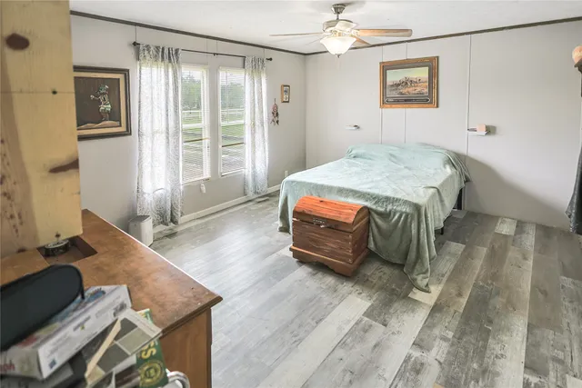 a bedroom with a bed and wooden floor