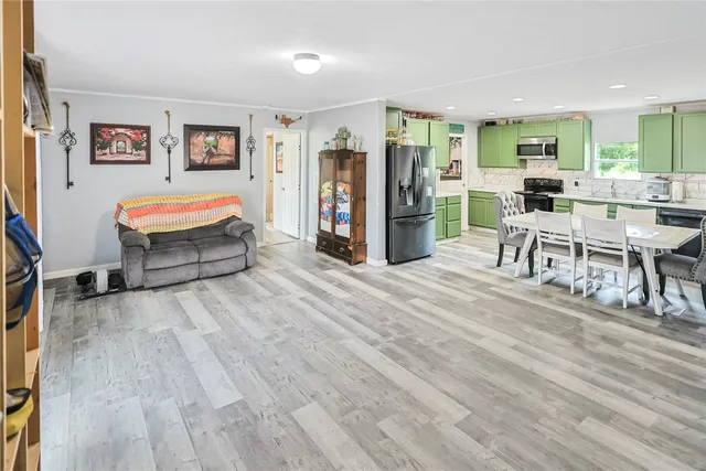 a living room with furniture and large mirror