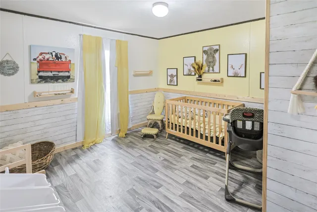 a view of a hallway with wooden floor and entryway
