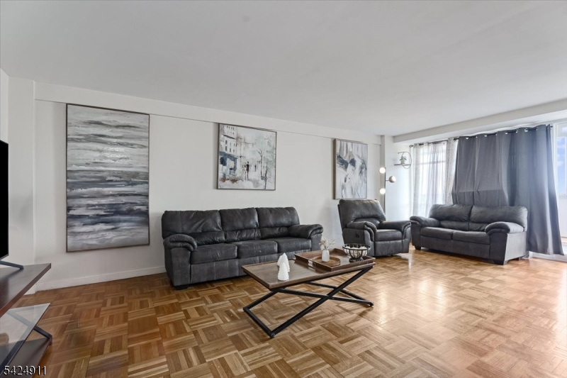 90 Prospect Avenue Hackensack, NJ 07601 - Photo 2 of 21 a living room with furniture and a flat screen tv