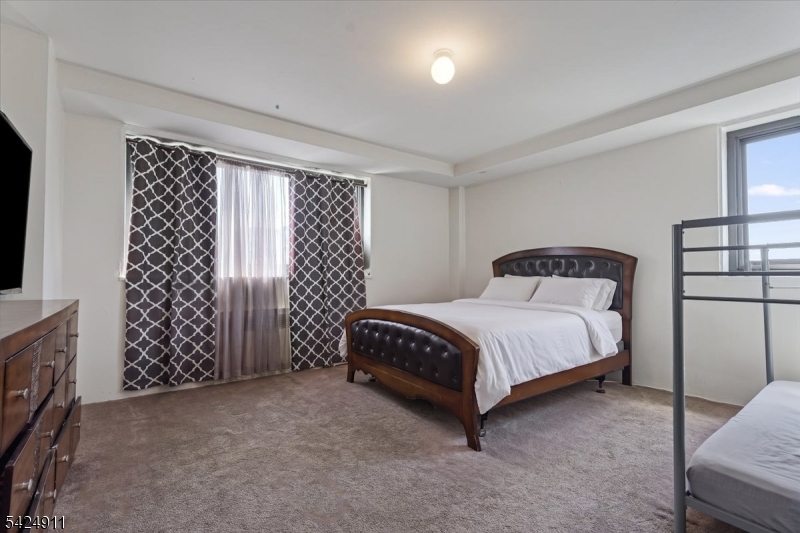 90 Prospect Avenue Hackensack, NJ 07601 - Photo 7 of 21 a bedroom with a bed and a window