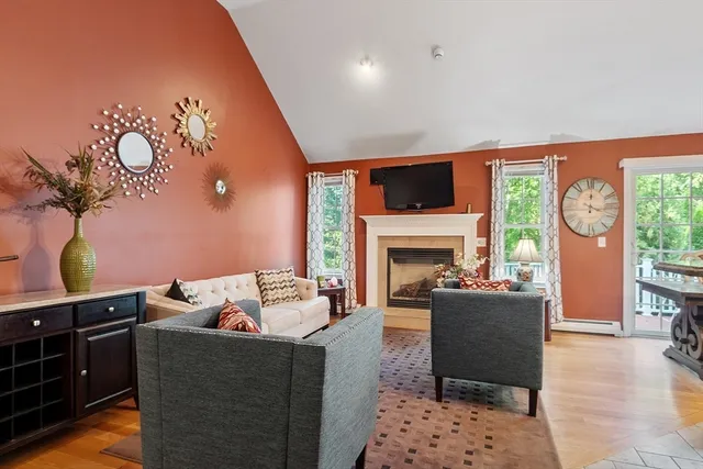 a living room with furniture a fireplace and a flat screen tv