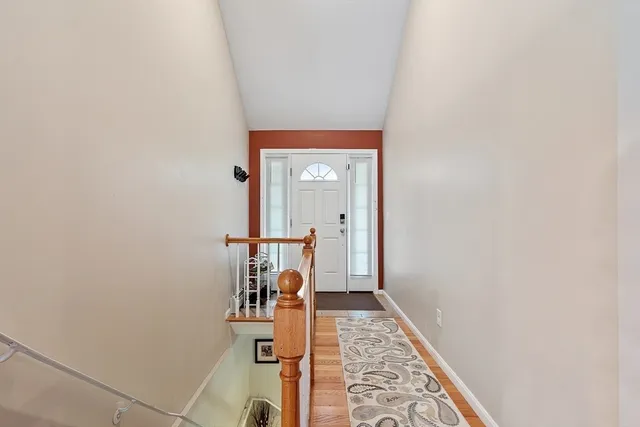 a view of a hallway with wooden floor and a hallway