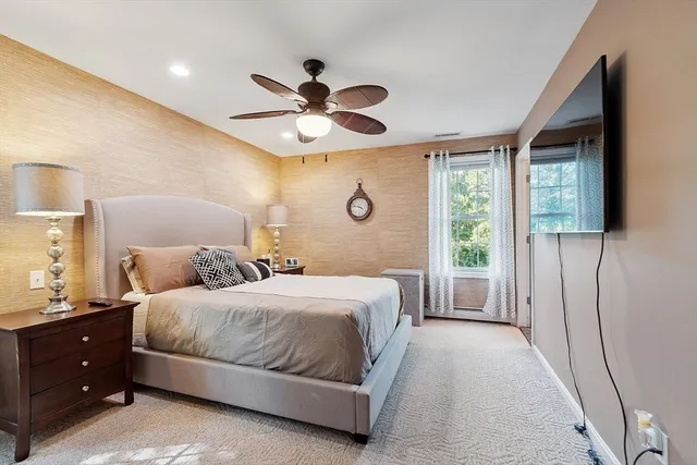 a bedroom with a large bed and a flat screen tv