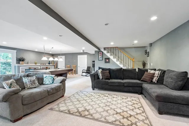 a living room with furniture and kitchen view