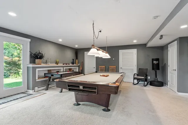 a room with pool table and windows