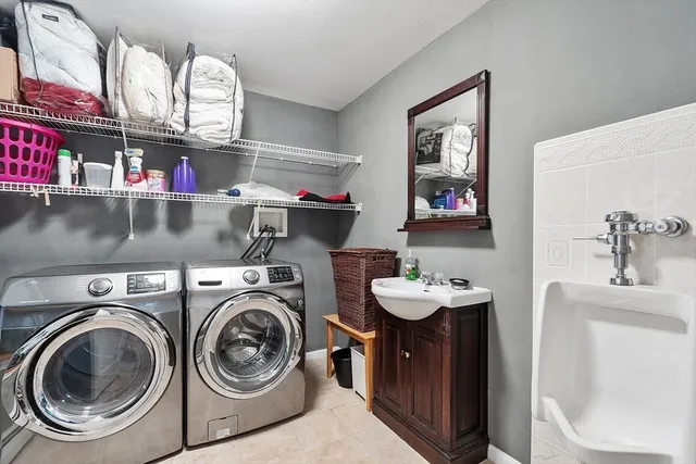 a utility room with dryer washer and a sink