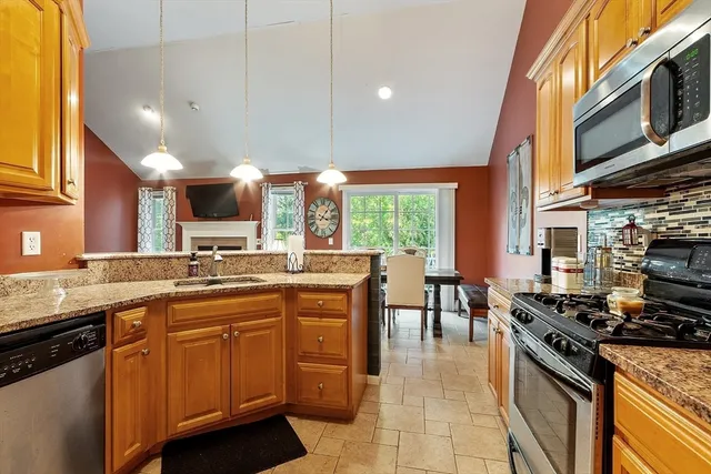 a kitchen with stainless steel appliances a sink stove and cabinets