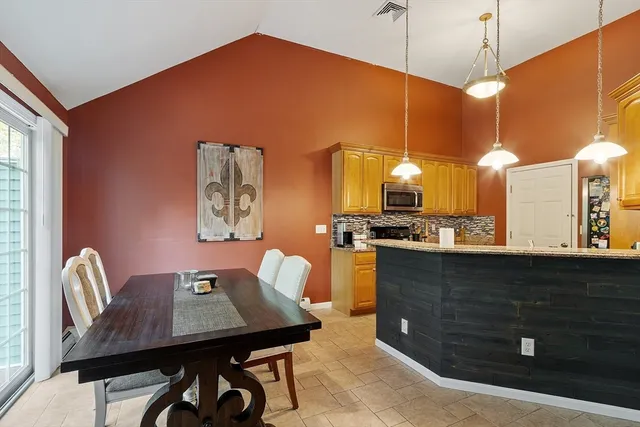 a view of a kitchen with dining table and chairs
