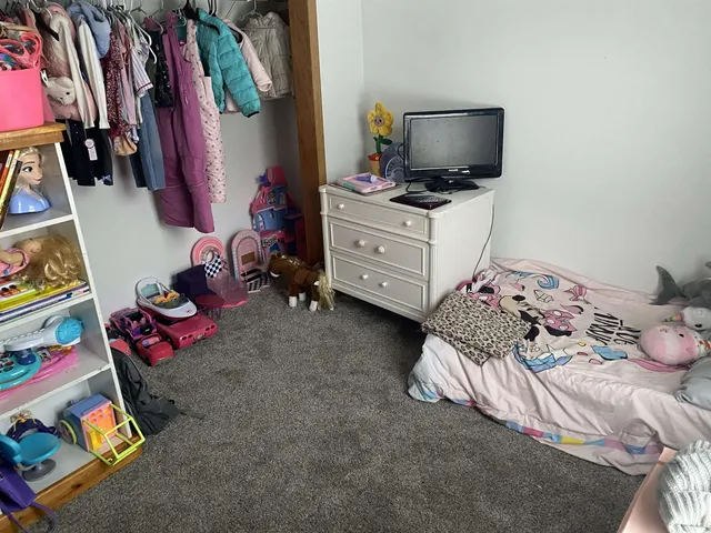 a bedroom with a bed and flat screen tv