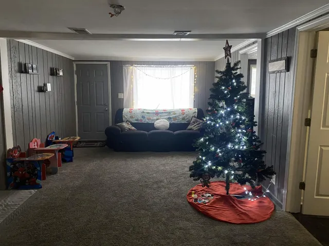 a living room with furniture and a chandelier