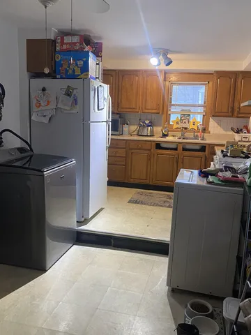 a kitchen with refrigerator and cabinets