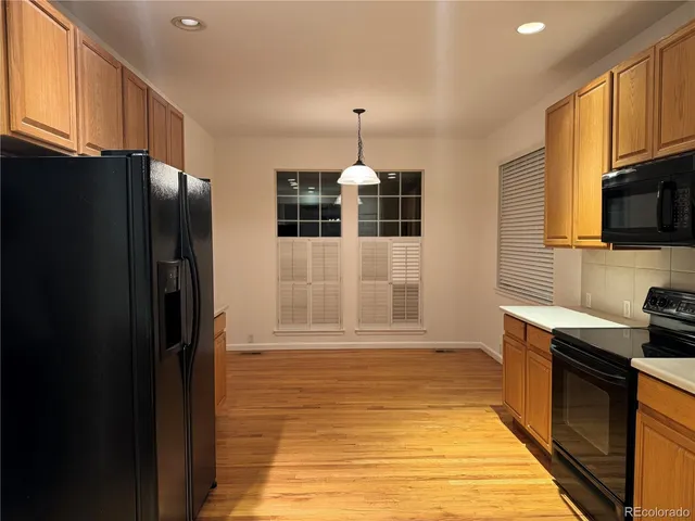 a kitchen with granite countertop cabinets stainless steel appliances and a sink