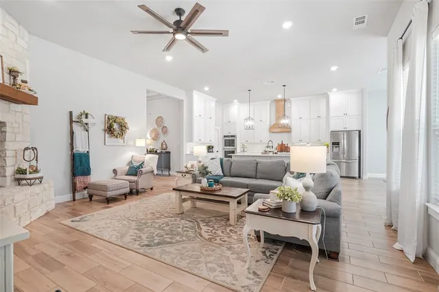 a living room with furniture and a ceiling fan
