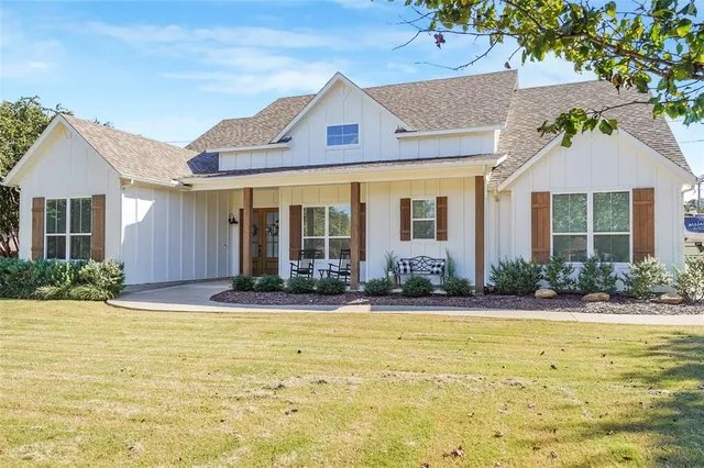 a front view of a house with swimming pool and porch