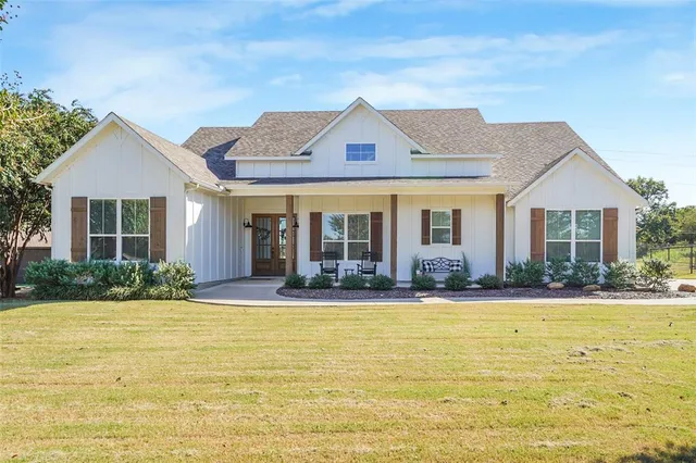 a front view of house with yard and green space
