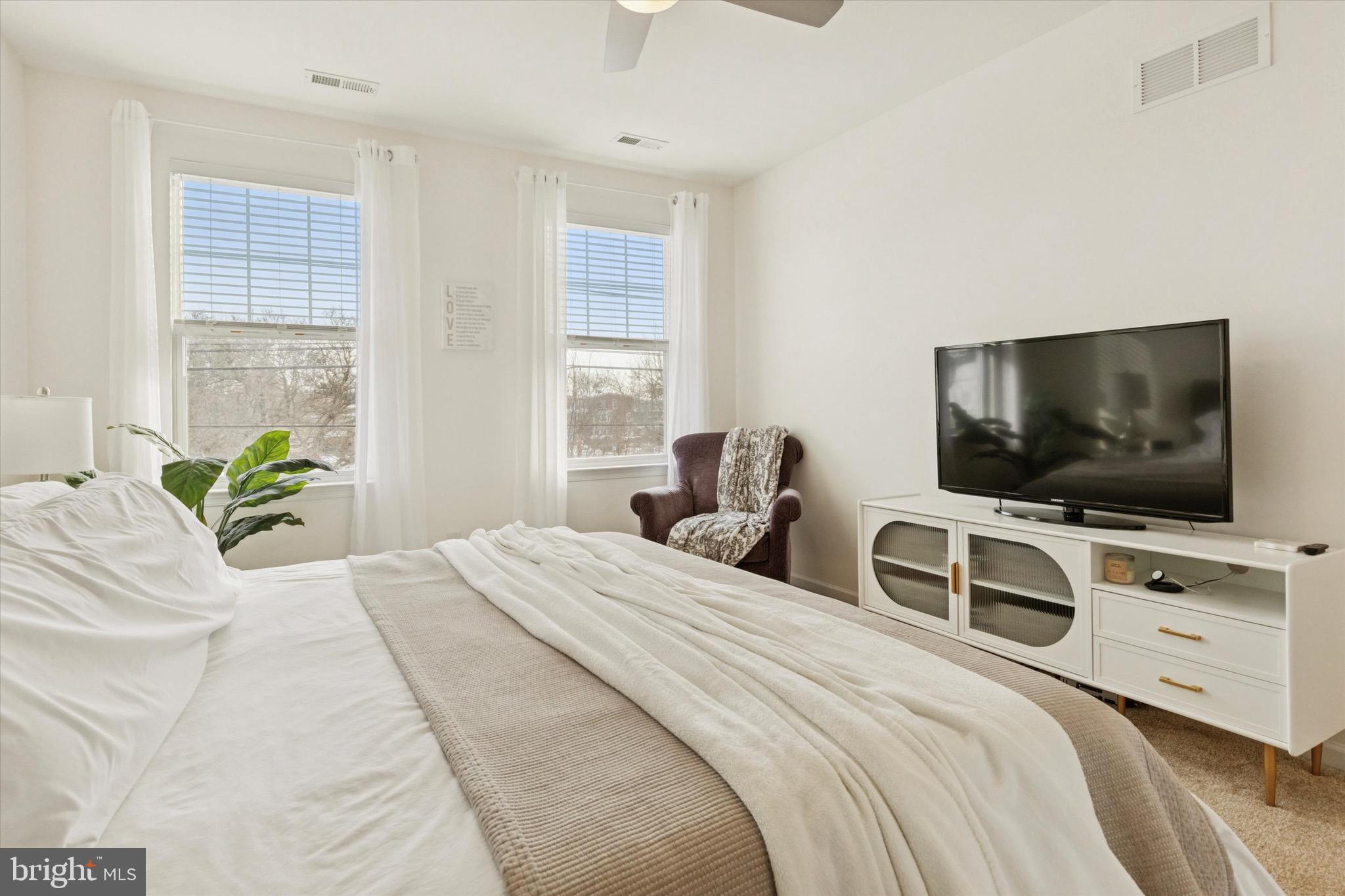 1529 DeKalb Street, Unit 131 Norristown, PA 19401 - Photo 17 of 27 a bedroom with a bed and a flat screen tv