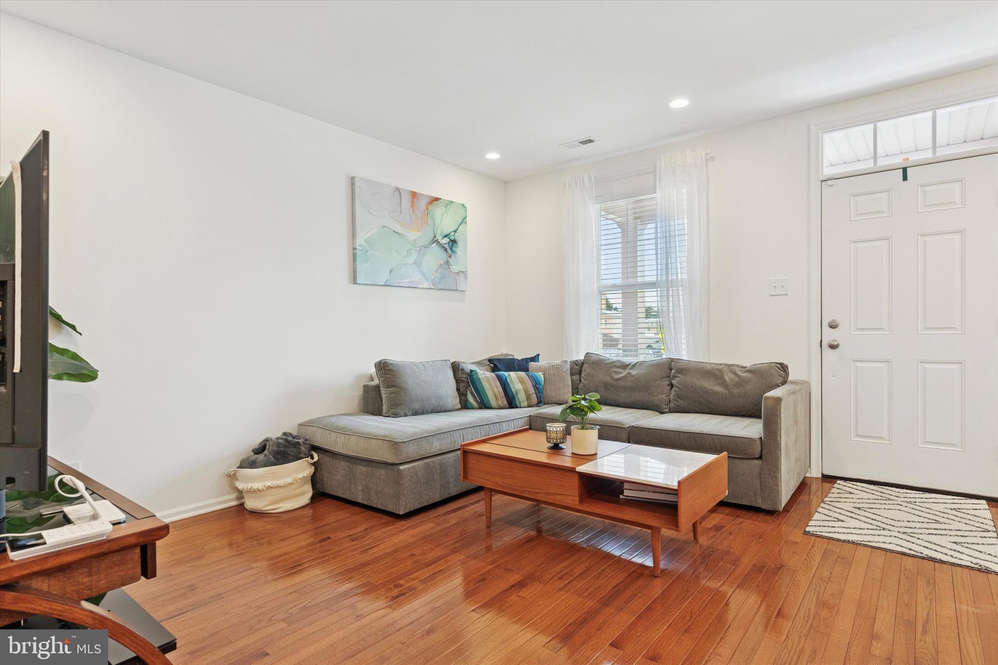 1529 DeKalb Street, Unit 131 Norristown, PA 19401 - Photo 5 of 27 a living room with furniture and a wooden floor