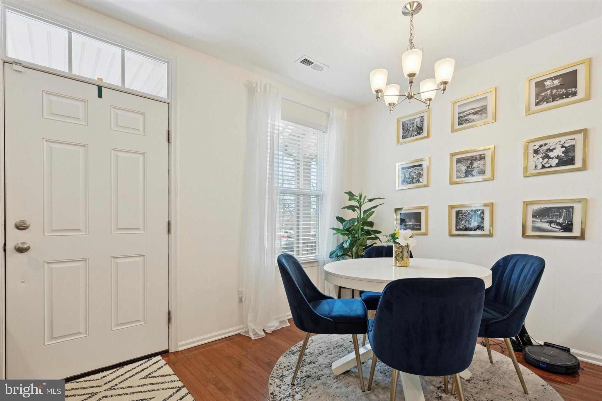 1529 DeKalb Street, Unit 131 Norristown, PA 19401 - Photo 7 of 27 a dining room with furniture a chandelier and wooden floor