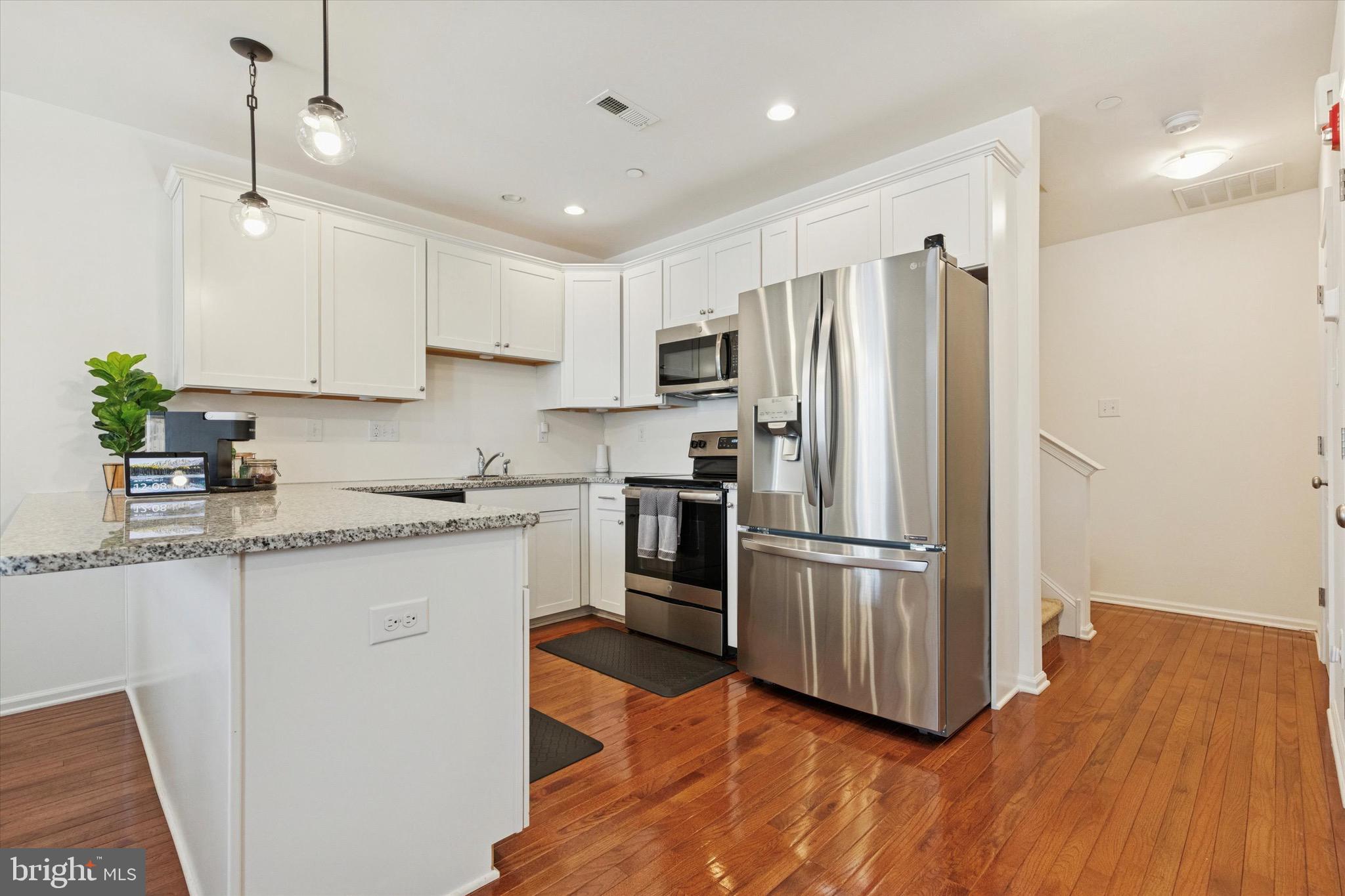 1529 DeKalb Street, Unit 131 Norristown, PA 19401 - Photo 9 of 27 a kitchen with granite countertop a refrigerator oven a sink dishwasher and a refrigerator