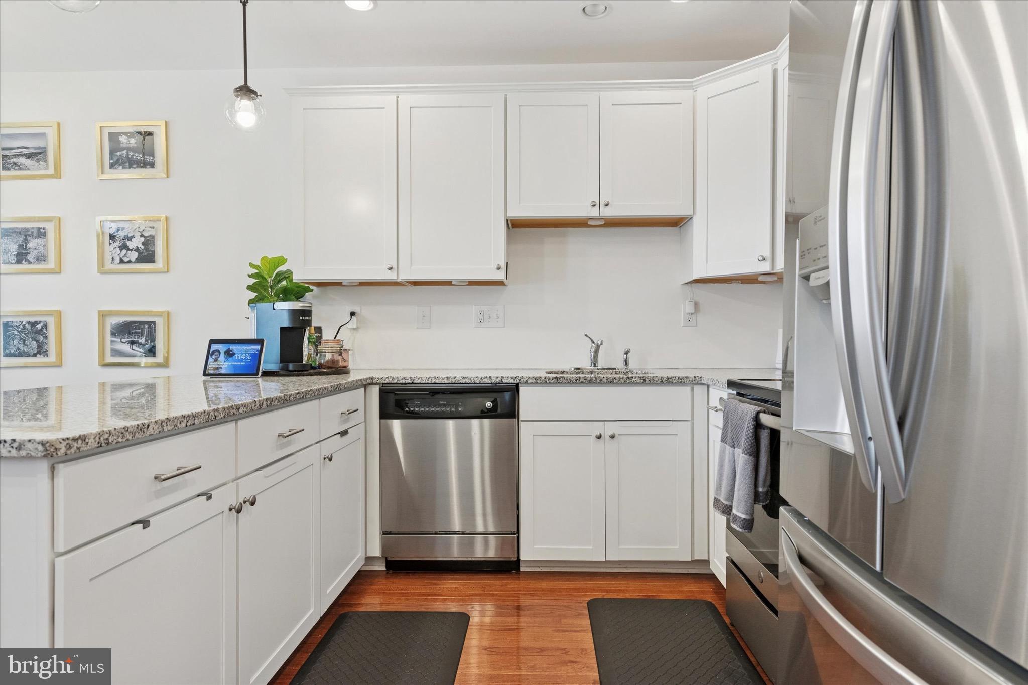 1529 DeKalb Street, Unit 131 Norristown, PA 19401 - Photo 10 of 27 a kitchen with stainless steel appliances granite countertop a refrigerator and white cabinets