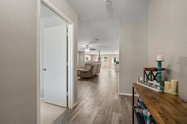 a view of a bedroom with a bed and wooden floor