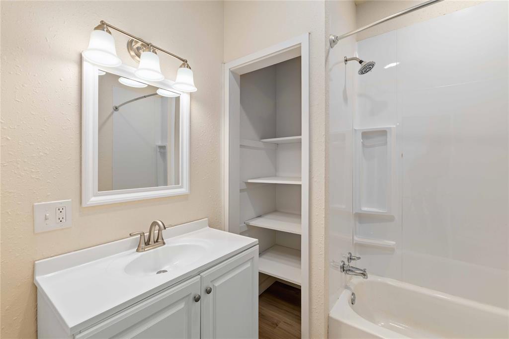 516 South Pecos Street Coleman, TX 76834 - Photo 13 of 32 a bathroom with a sink and a mirror