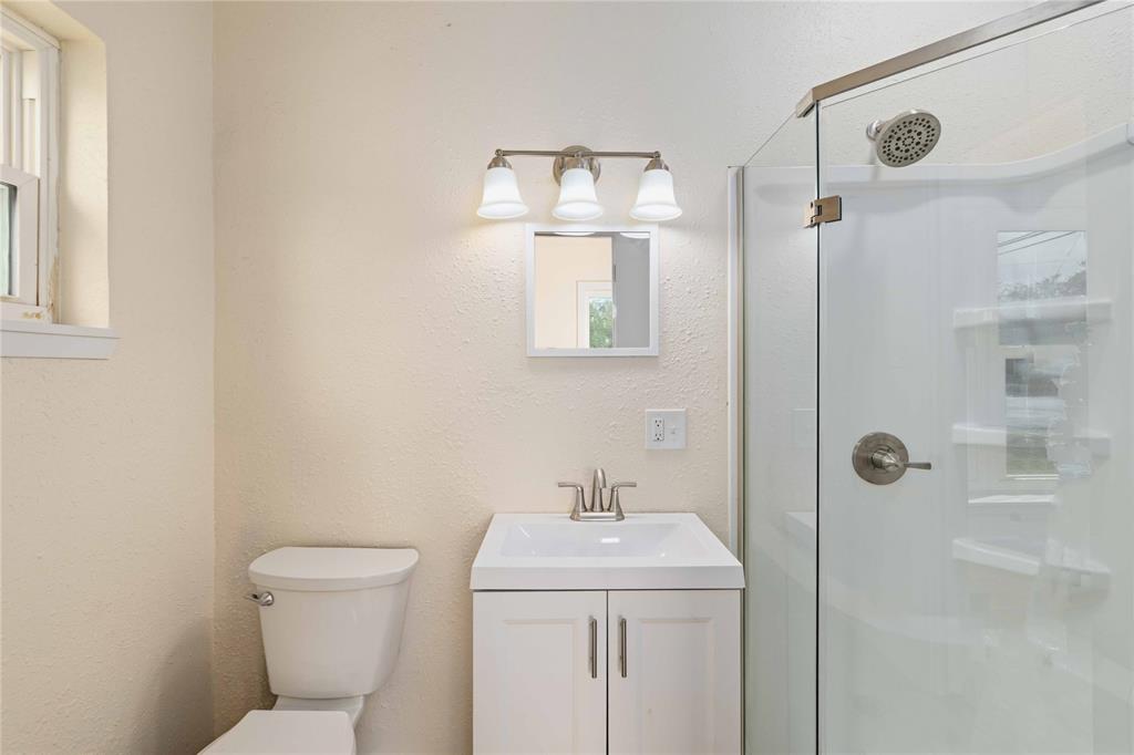 516 South Pecos Street Coleman, TX 76834 - Photo 18 of 32 a bathroom with a toilet sink and shower