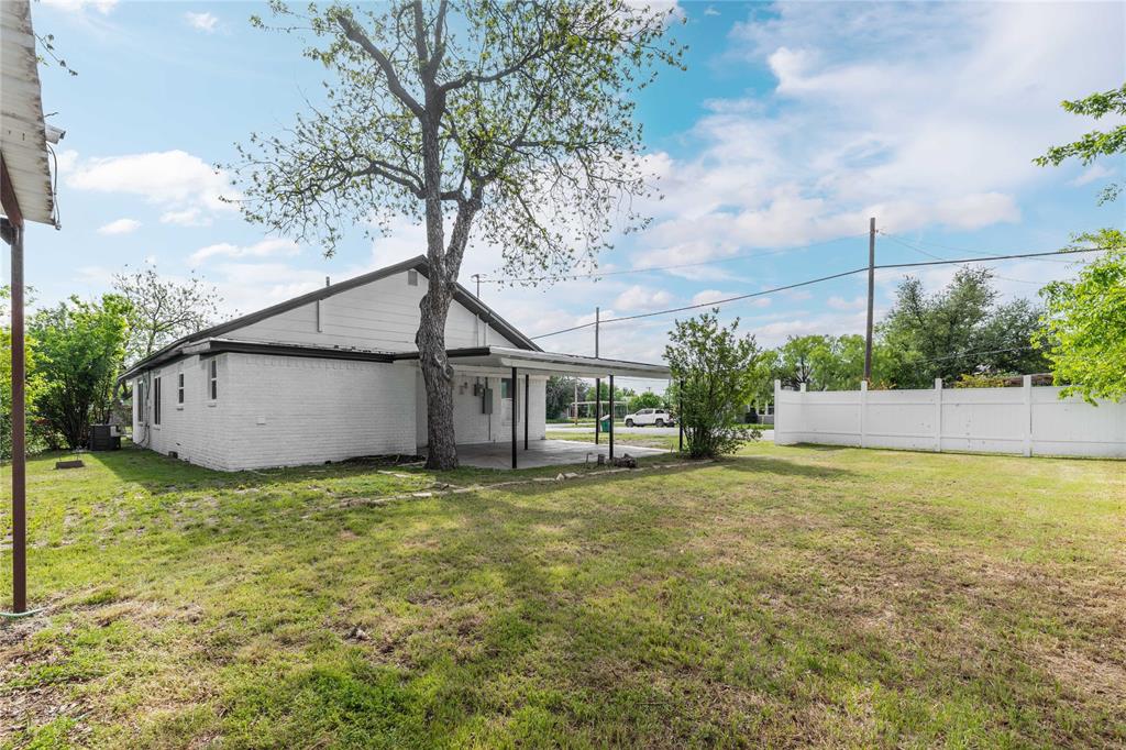 516 South Pecos Street Coleman, TX 76834 - Photo 30 of 32 a house that has a tree in front of it