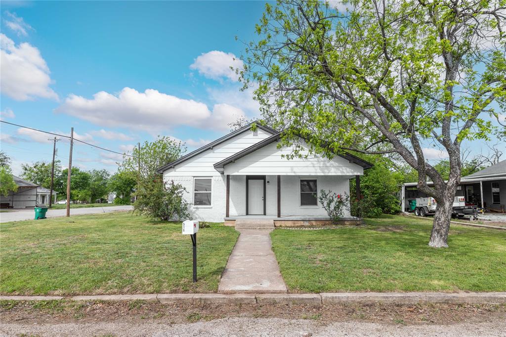 516 South Pecos Street Coleman, TX 76834 - Photo 3 of 32 a front view of a house with garden